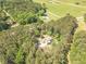 A high angle shot of a residence with mature trees on a parcel near a grass field at 830 Hightower Trl, Oxford, GA 30054