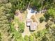 Birds eye view of a single Gathering house with long driveway and surrounded by dense woods at 830 Hightower Trl, Oxford, GA 30054