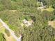 A high angle shot of a residence with mature trees on a parcel near a road at 830 Hightower Trl, Oxford, GA 30054