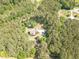 Stunning aerial view of a secluded home nestled among lush greenery and mature trees at 830 Hightower Trl, Oxford, GA 30054