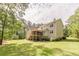 Expansive backyard featuring a multi-level deck and lush landscaping at 830 Hightower Trl, Oxford, GA 30054