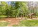 Lush backyard featuring mature trees and an outdoor lounge area at 830 Hightower Trl, Oxford, GA 30054