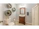 Inviting bathroom features a wooden vanity, decorative wall shelves, and neutral tones at 830 Hightower Trl, Oxford, GA 30054