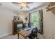 A bedroom currently being used as office space, featuring a computer setup, natural light, and decor at 830 Hightower Trl, Oxford, GA 30054