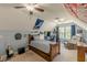 A spacious bedroom includes sports decor, a fan, window, recliner and ceiling fan at 830 Hightower Trl, Oxford, GA 30054