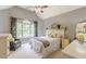Bright bedroom with vaulted ceilings, fan, large window, and neutral decor at 830 Hightower Trl, Oxford, GA 30054
