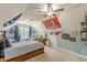 A cozy, carpeted bedroom includes sports decor, a fan, window, chair, desk and ceiling fan at 830 Hightower Trl, Oxford, GA 30054
