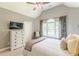 Comfortable bedroom with vaulted ceiling, fan, large window and neutral decor at 830 Hightower Trl, Oxford, GA 30054