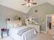 Comfortable bedroom with vaulted ceiling, fan, and neutral decor and a connected hall at 830 Hightower Trl, Oxford, GA 30054