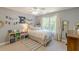 Cozy bedroom featuring a queen bed, a ceiling fan and a natural light from a window at 830 Hightower Trl, Oxford, GA 30054