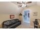 A bonus room includes a black leather sofa, and leads to the bedroom through a doorway at 830 Hightower Trl, Oxford, GA 30054