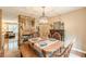 Dining area showcases a stone fireplace, bench seating, and charming decor at 830 Hightower Trl, Oxford, GA 30054