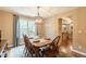Cozy dining room with wood table and chairs, chandelier, and lots of natural light at 830 Hightower Trl, Oxford, GA 30054