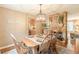 Inviting dining room features a stone fireplace and views into the kitchen and living room at 830 Hightower Trl, Oxford, GA 30054