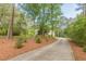 Long private driveway leading through a beautiful wooded area to home at 830 Hightower Trl, Oxford, GA 30054