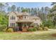 Charming two-story home featuring a stone turret and inviting front porch at 830 Hightower Trl, Oxford, GA 30054