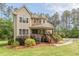 Charming two-story home featuring a stone turret and inviting front porch at 830 Hightower Trl, Oxford, GA 30054