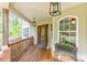 Inviting front porch with wood floors, lantern lighting, and arched windows at 830 Hightower Trl, Oxford, GA 30054