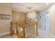 Upstairs hallway featuring a chandelier, wood railings, and access to bedrooms and bathrooms at 830 Hightower Trl, Oxford, GA 30054