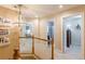 Well-lit upstairs hallway featuring a chandelier and views into the bedrooms and bathroom at 830 Hightower Trl, Oxford, GA 30054