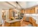Bright kitchen features wood cabinets, an island with cooktop, and stainless steel appliances at 830 Hightower Trl, Oxford, GA 30054