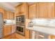 Kitchen features stainless steel appliances, wood cabinets, and tile backsplash at 830 Hightower Trl, Oxford, GA 30054