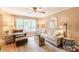 Bright living room with large window, neutral color palette, and comfortable seating at 830 Hightower Trl, Oxford, GA 30054