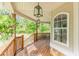 Charming covered porch with wood railing and views of the lush green yard at 830 Hightower Trl, Oxford, GA 30054
