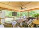 Well-furnished screened porch with TV, grill, and comfortable seating at 830 Hightower Trl, Oxford, GA 30054