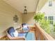 Inviting porch with seating area and hanging plants, perfect for relaxing outdoors at 830 Hightower Trl, Oxford, GA 30054