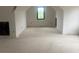 Expansive unfinished attic with a window offering natural light, presenting an opportunity for customization at 1089 Mount Carmel Church Ln, Canton, GA 30114