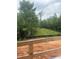 View from patio of wooded backyard with construction materials visible at 1089 Mount Carmel Church Ln, Canton, GA 30114