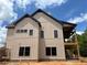 Side view of new home with black framed windows and covered porch at 1089 Mount Carmel Church Ln, Canton, GA 30114