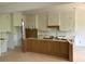 Unfinished kitchen with white cabinets and a center island awaits its final touches at 1089 Mount Carmel Church Ln, Canton, GA 30114