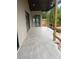 View of covered patio with wood posts and gray tile flooring at 1089 Mount Carmel Church Ln, Canton, GA 30114