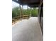 Spacious covered patio with tile flooring and view of wooded backyard at 1089 Mount Carmel Church Ln, Canton, GA 30114
