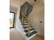 Elegant staircase featuring wooden railings and modern design, enhancing the home's architectural appeal at 1089 Mount Carmel Church Ln, Canton, GA 30114