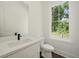 Bright bathroom with a modern vanity, toilet, and a window offering natural light at 2150 Tidwell Ln # 5, Atlanta, GA 30318