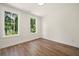 Bedroom with hardwood floors and large windows with views of wooded exterior at 2150 Tidwell Ln # 5, Atlanta, GA 30318