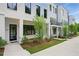 Modern townhome showcasing a black front door, black framed windows, and manicured landscaping at 2150 Tidwell Ln # 5, Atlanta, GA 30318