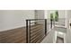 Hallway with hardwood floors and modern black metal railings at 2150 Tidwell Ln # 5, Atlanta, GA 30318