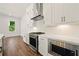 Modern kitchen featuring white cabinets, stainless steel appliances, and bright countertops at 2150 Tidwell Ln # 5, Atlanta, GA 30318