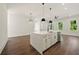 Open kitchen featuring an island with a sink, stainless steel appliances, and modern pendant lights at 2150 Tidwell Ln # 5, Atlanta, GA 30318