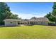 Aerial view of the property with large backyard, outbuilding, and covered patio at 3134 Milloak Ct, Buford, GA 30519