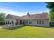 Wide view of backyard highlighting the covered patio and large lawn at 3134 Milloak Ct, Buford, GA 30519