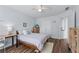 Bedroom featuring wood floors, a ceiling fan, large window, and neutral, light colored walls at 3134 Milloak Ct, Buford, GA 30519