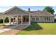 Backyard view of home featuring a covered patio, well-maintained lawn, and mature landscaping at 3134 Milloak Ct, Buford, GA 30519