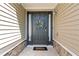 Stylish front door with sidelights, decorative wreath, and welcome mat, creating a warm entrance at 3134 Milloak Ct, Buford, GA 30519