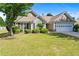 Beautiful single-story home with a well-maintained lawn, landscaped bushes, and an attached two-car garage at 3134 Milloak Ct, Buford, GA 30519