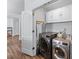 Convenient laundry room with modern washer and dryer, overhead cabinets, and plenty of storage space at 3134 Milloak Ct, Buford, GA 30519